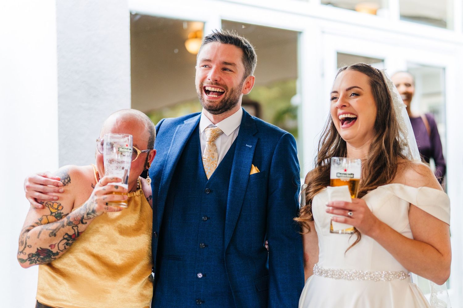 Poulaphouca Wedding photographer wicklow  A joyful moment of laughter shared during wedding festivities outdoors.