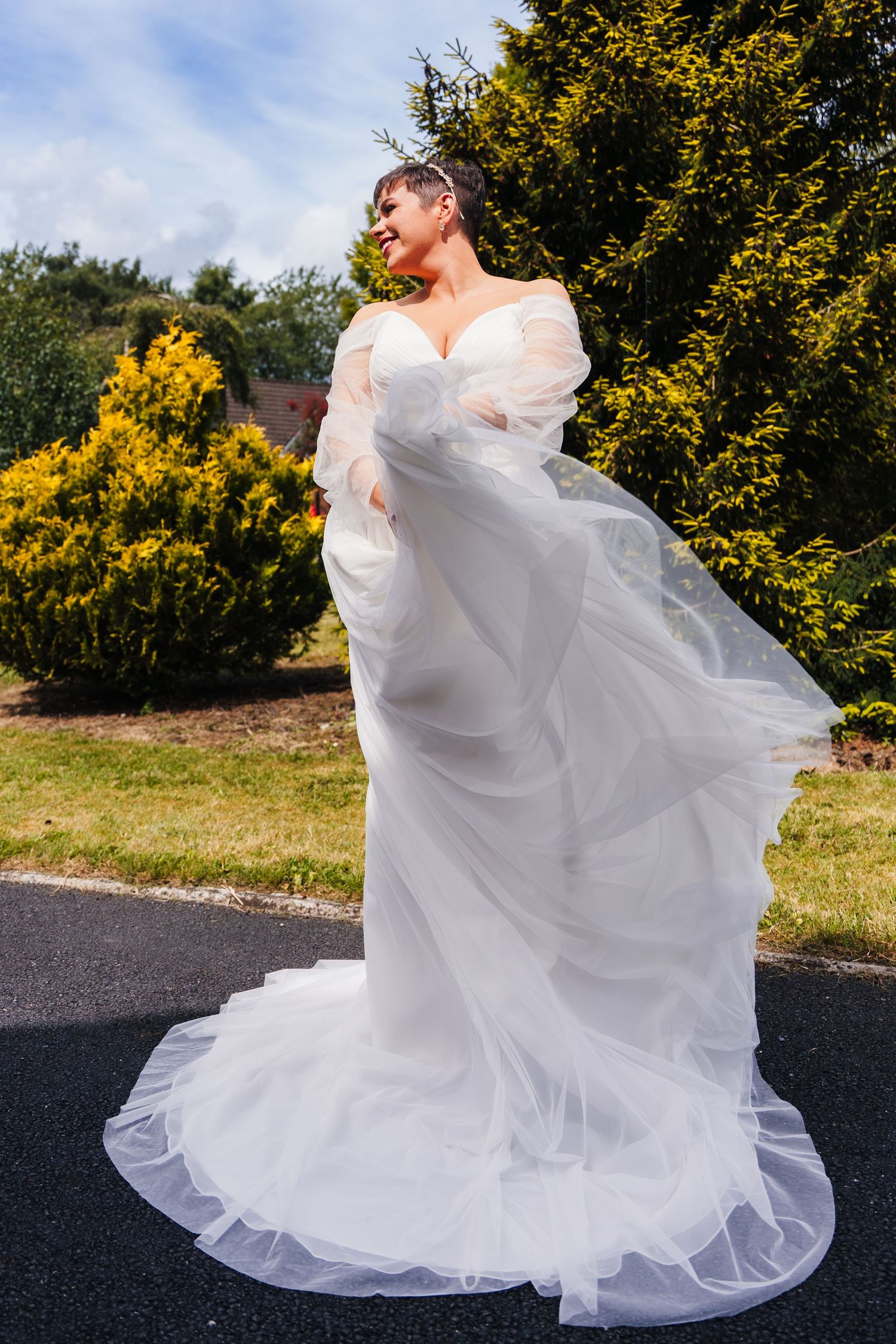 Millhouse slane wedding photographer dubA flowing white wedding dress twirls dramatically against a backdrop of yellow flowers and greenery.