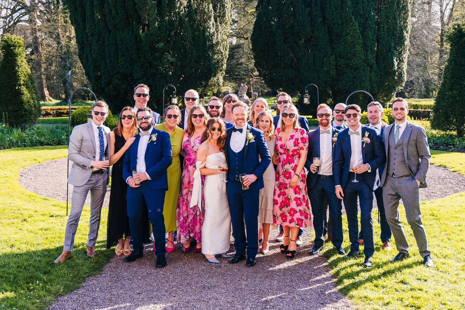Castle Leslie Wedding Photographer Dublin Large wedding party group photo taken outdoors on a sunny spring day.