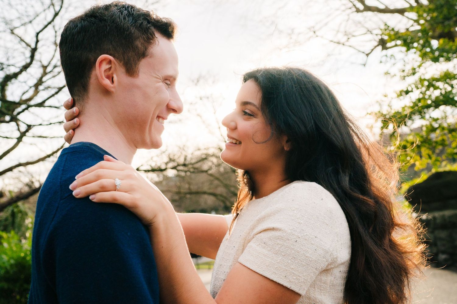 A romantic couple shares intimate moments during a golden hour outdoor photoshoot in a natural setting. Surprise proposal dublin photography