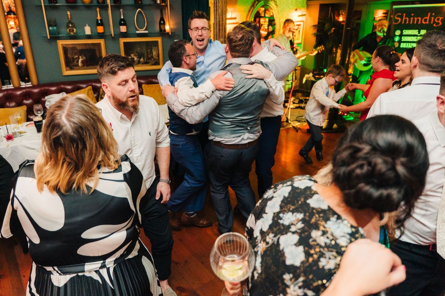 Lively dance floor scene at a wedding reception with guests celebrating. Marco Pierre Dublin Wedding Photographer