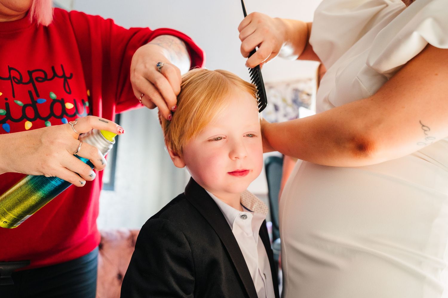 Multiple hands style hair using various products and styling tools in a bright indoor setting. City Hall Dublin Photographer