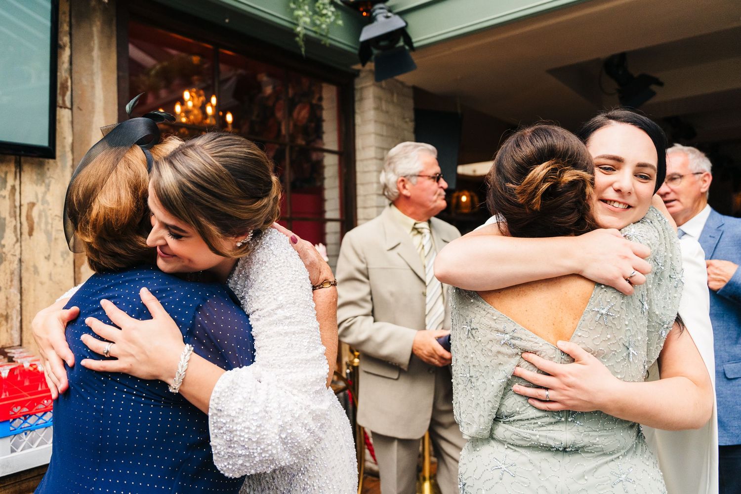 Emotional embraces shared between wedding guests during a celebration. House Dublin Wedding Photographer