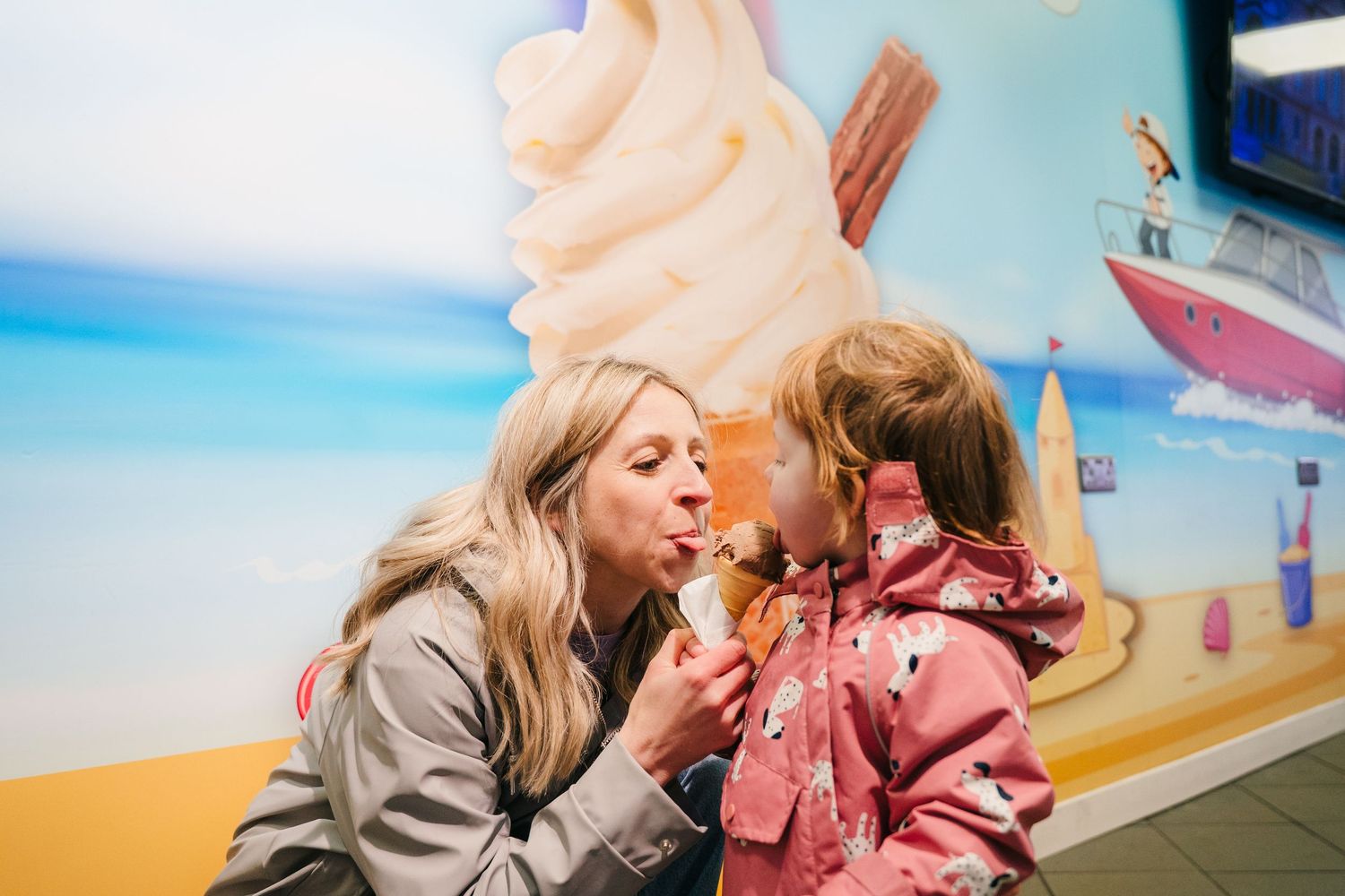 Sharing a sweet ice cream moment against a bright blue wall backdrop. PHOTOGRAPHER Dublin
