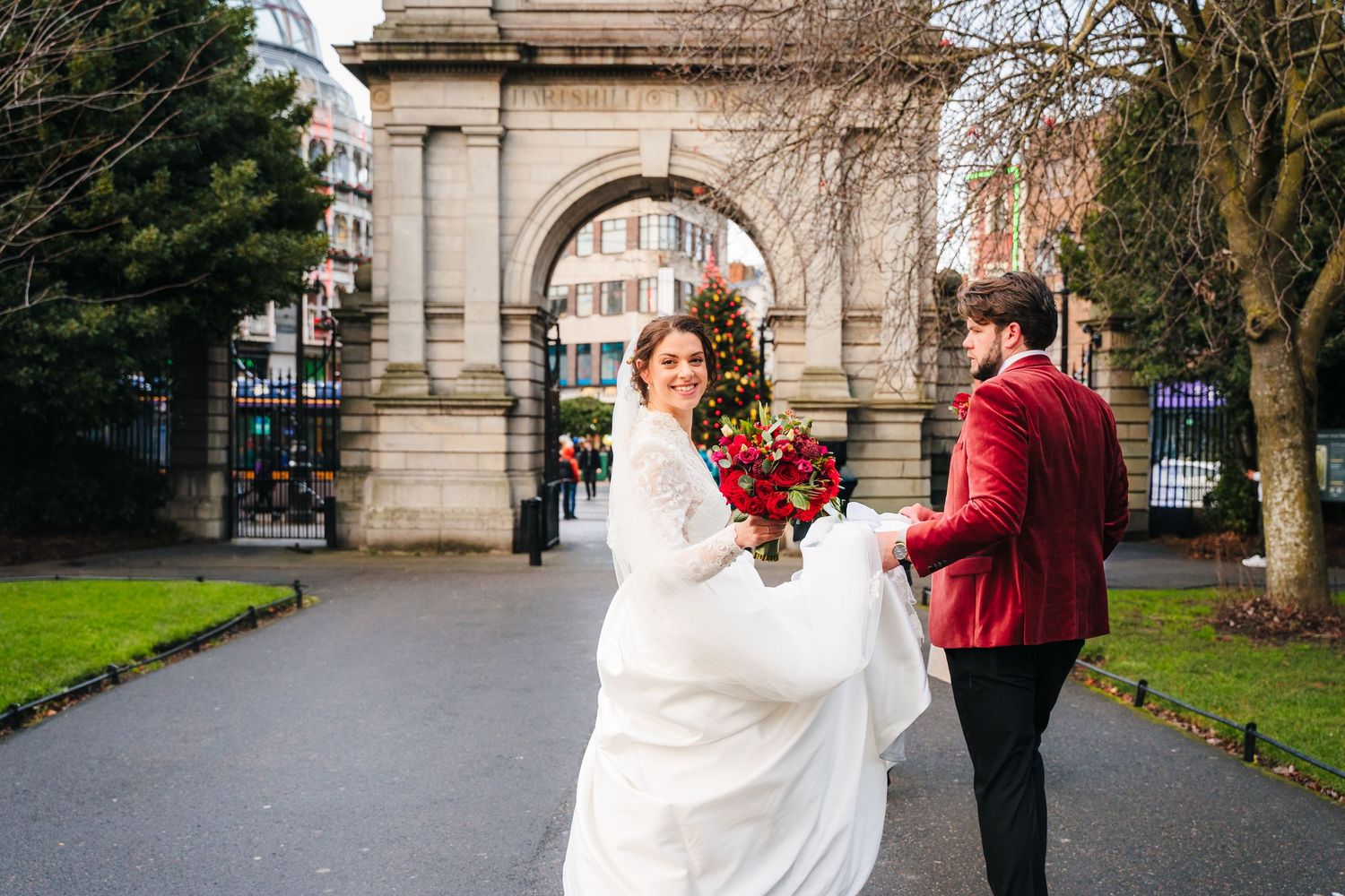 Couple dancing together outdoors near a stone archway in a garden setting. Stephens green club dublin Wedding photographer