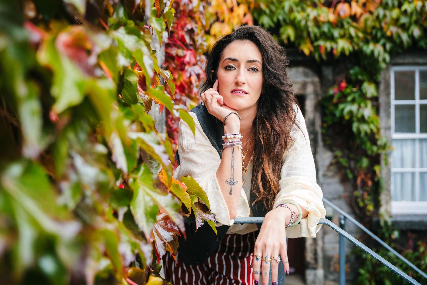 Autumn portrait session in front of colorful ivy covered wall with natural lighting . Professional headshots PHOTOGRAPHER Dublin