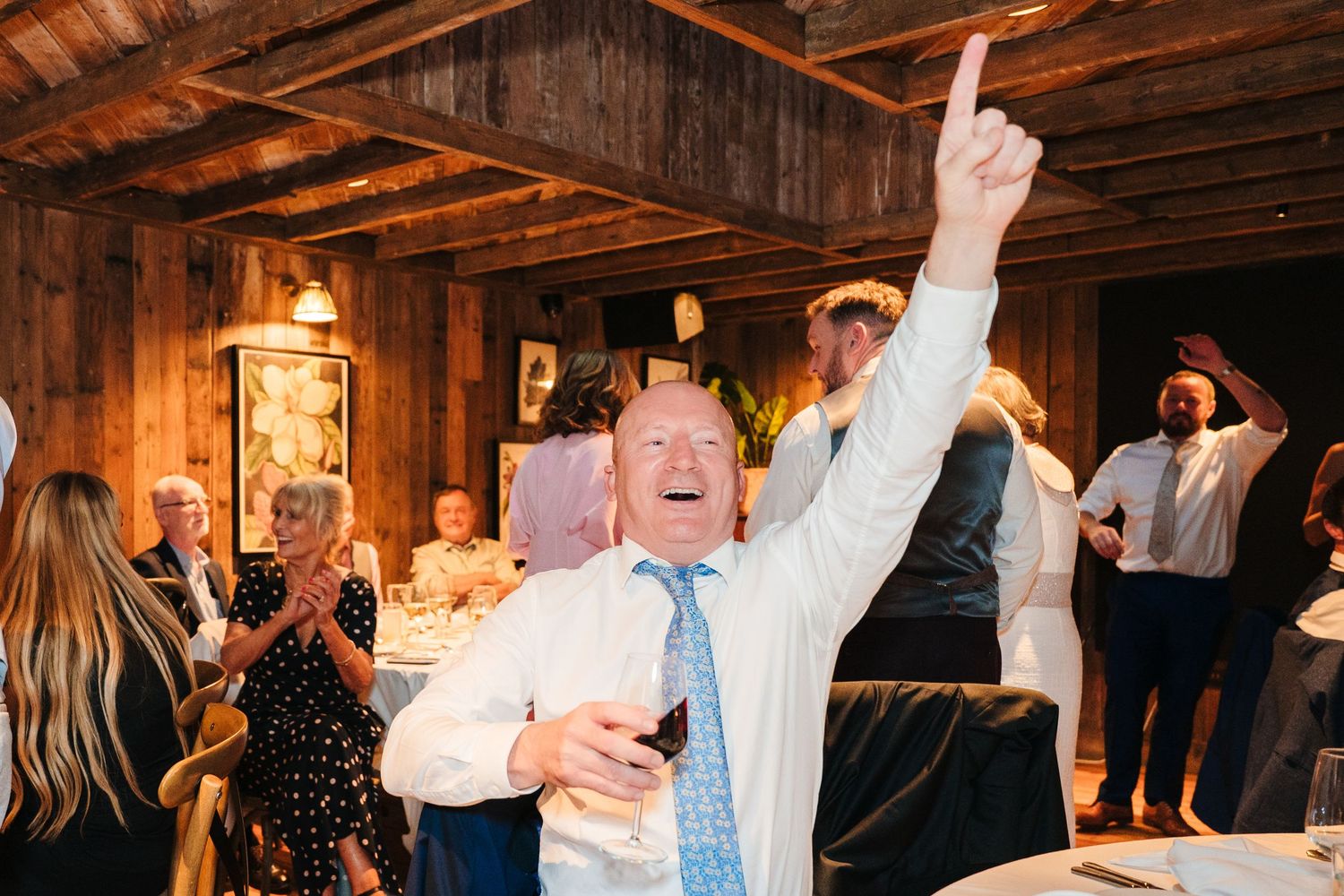 Wedding reception celebration with dancing and festivities in a rustic wooden barn venue. The Dean Dublin Wedding Photographer