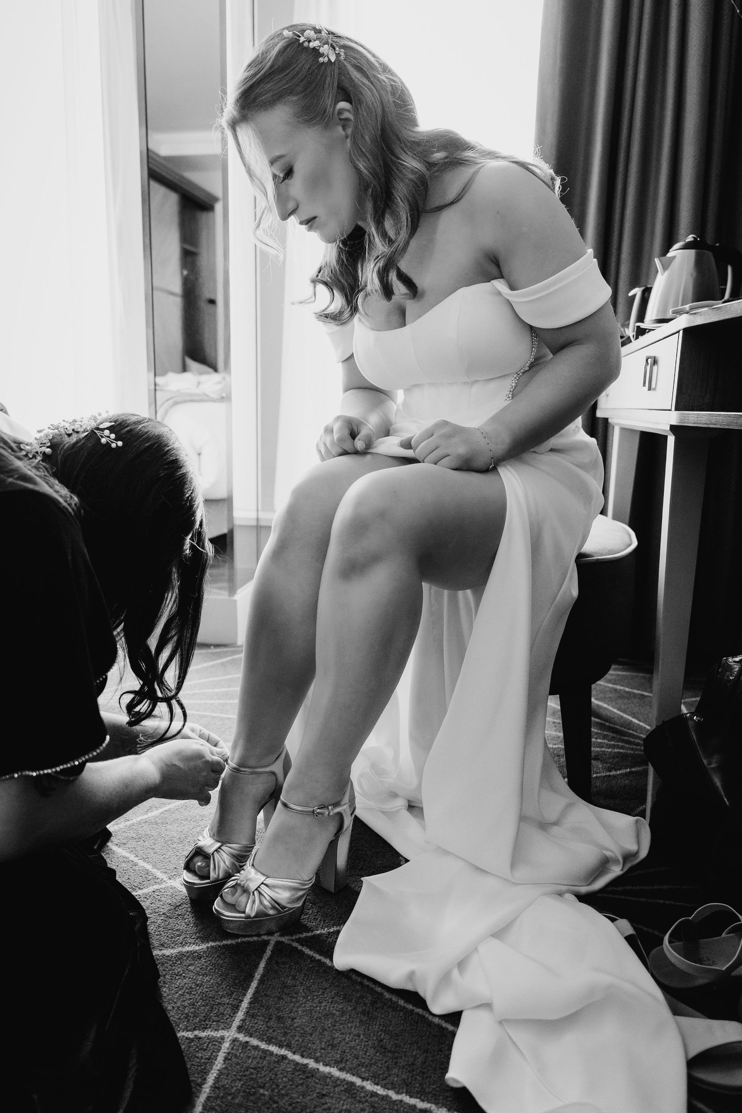 Close-up black and white shots of a bride putting on white shoes during wedding preparations. Dublin wedding photogrAPher Bewleys Grafton