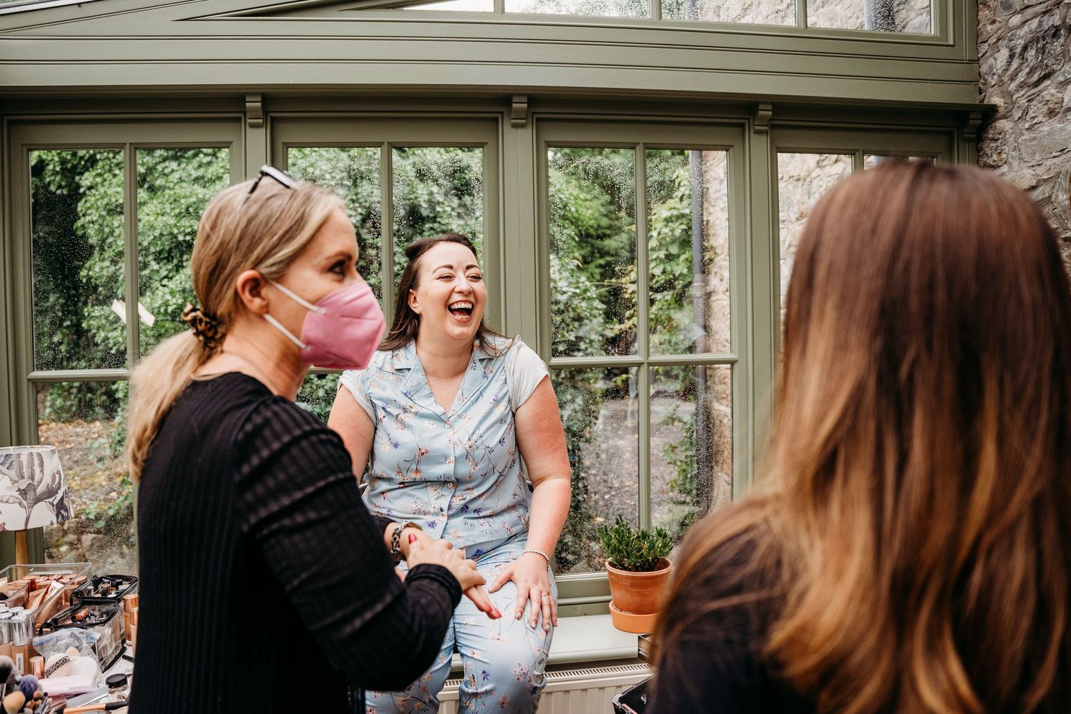 A series of candid moments at a social gathering show people laughing and interacting in an indoor setting. Wedding photographer Dublin