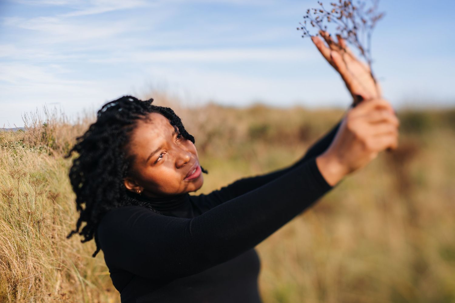 Expressive dance-like movements captured against a golden field at sunset. Dublin professional headshots photographer