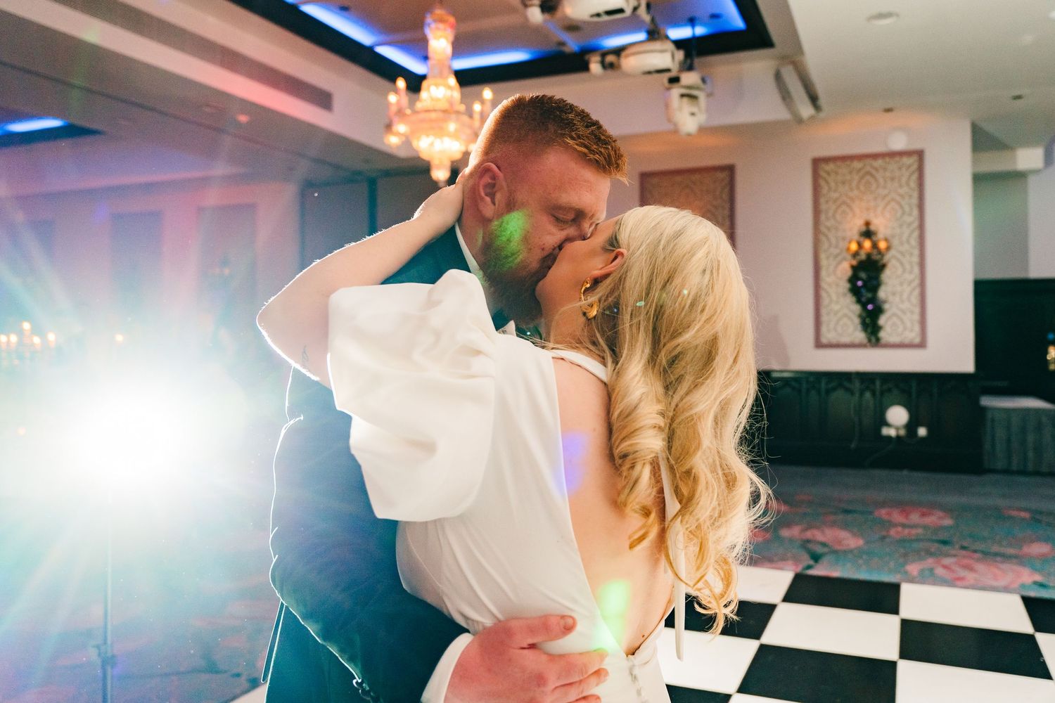 Wedding couple dancing in a modern venue with blue accent lighting. Wedding photographer dublin