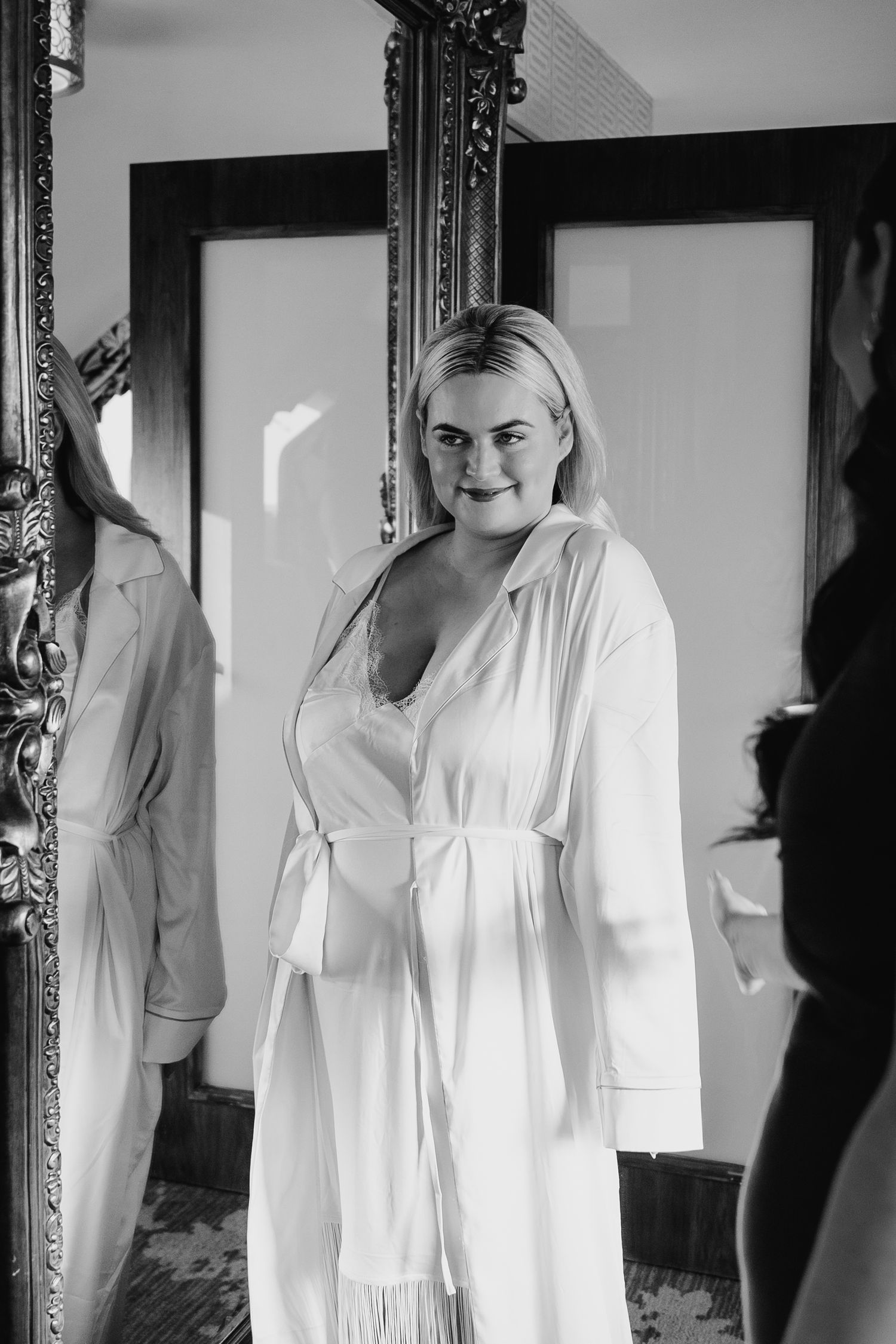 Series of black and white portraits in ornate frames against white wall. Wedding photographer dublin
