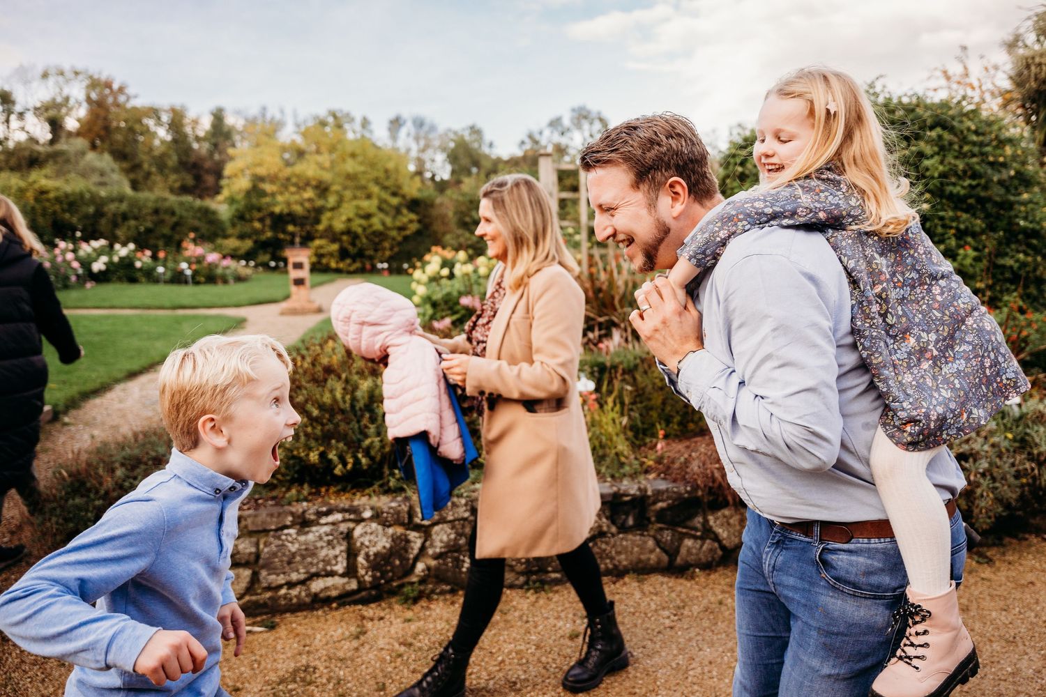 A series of candid lifestyle photographs captured outdoors during a fall photo session showing playful family moments in nature. family PHOT