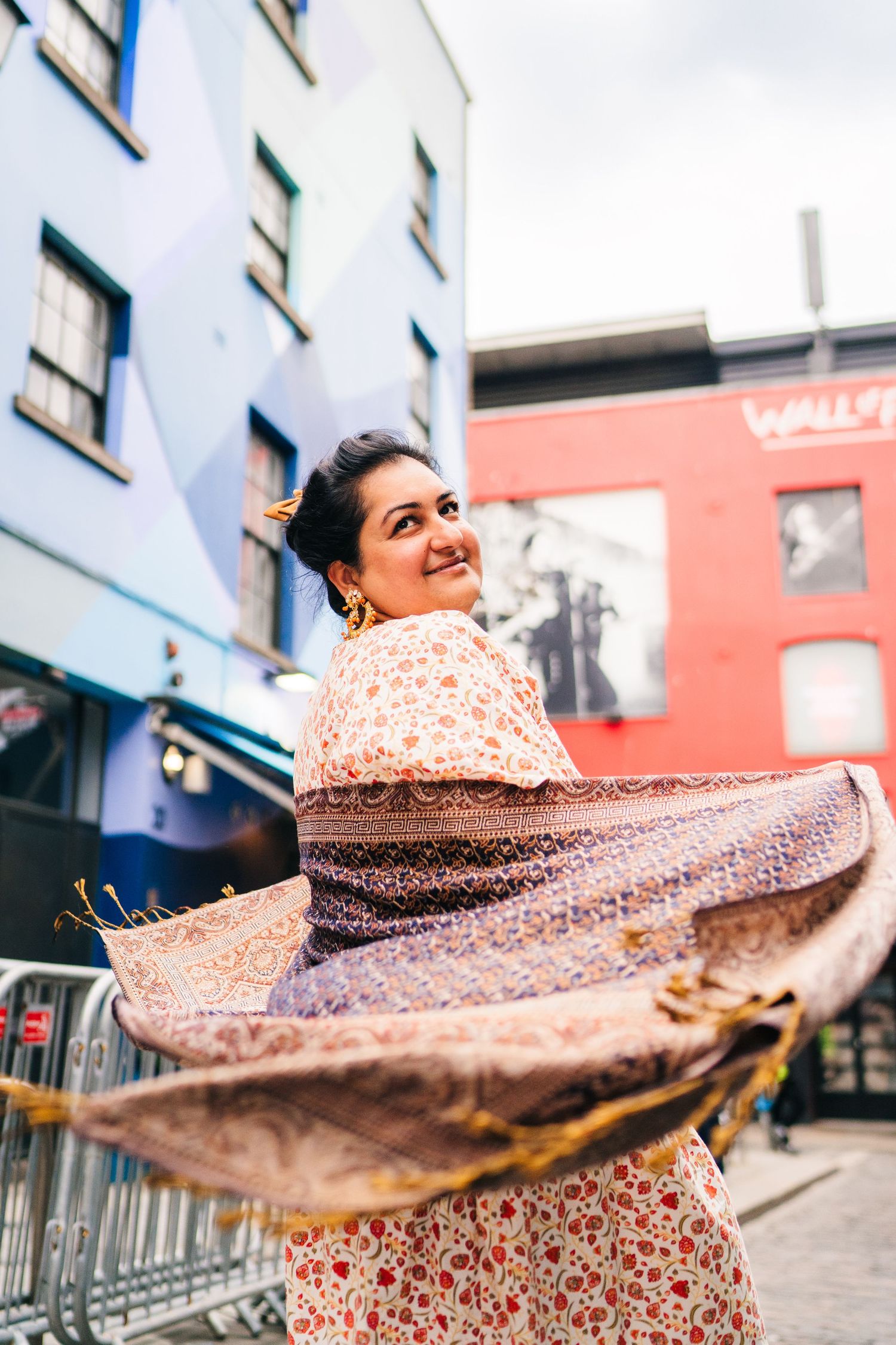 A person in a flowing floral dress spins and twirls joyfully against an urban backdrop. PHOTOGRAPHER Dublin ireland