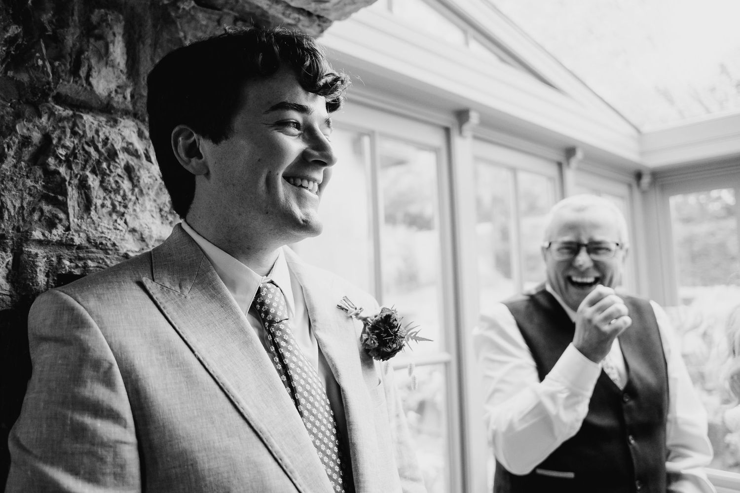 Elegant wedding celebration captured in black and white with guests enjoying indoor reception. Wedding photographer Dublin