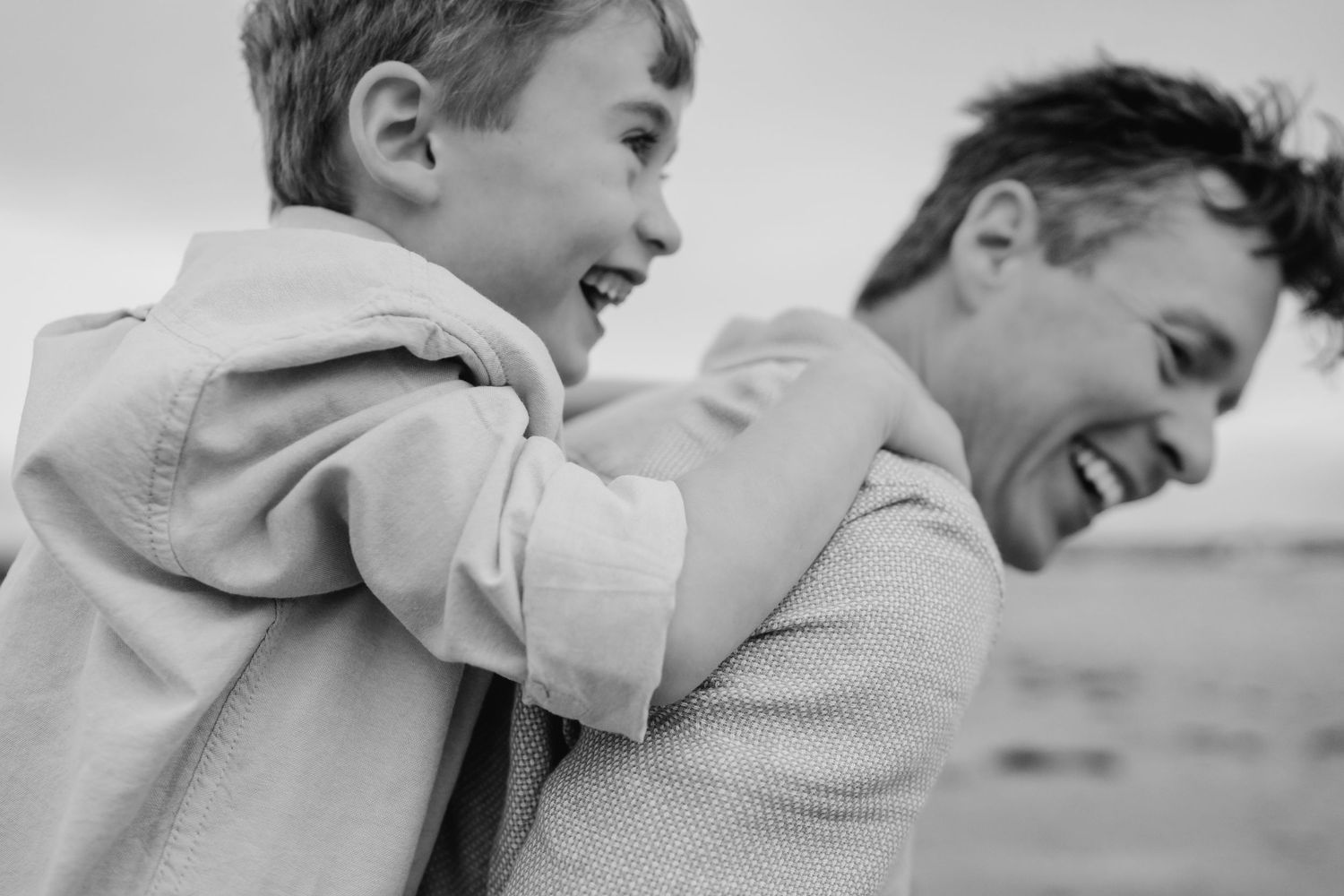 Joyful black and white portrait of a couple sharing an intimate moment in nature.  Family photographer Dublin Ireland