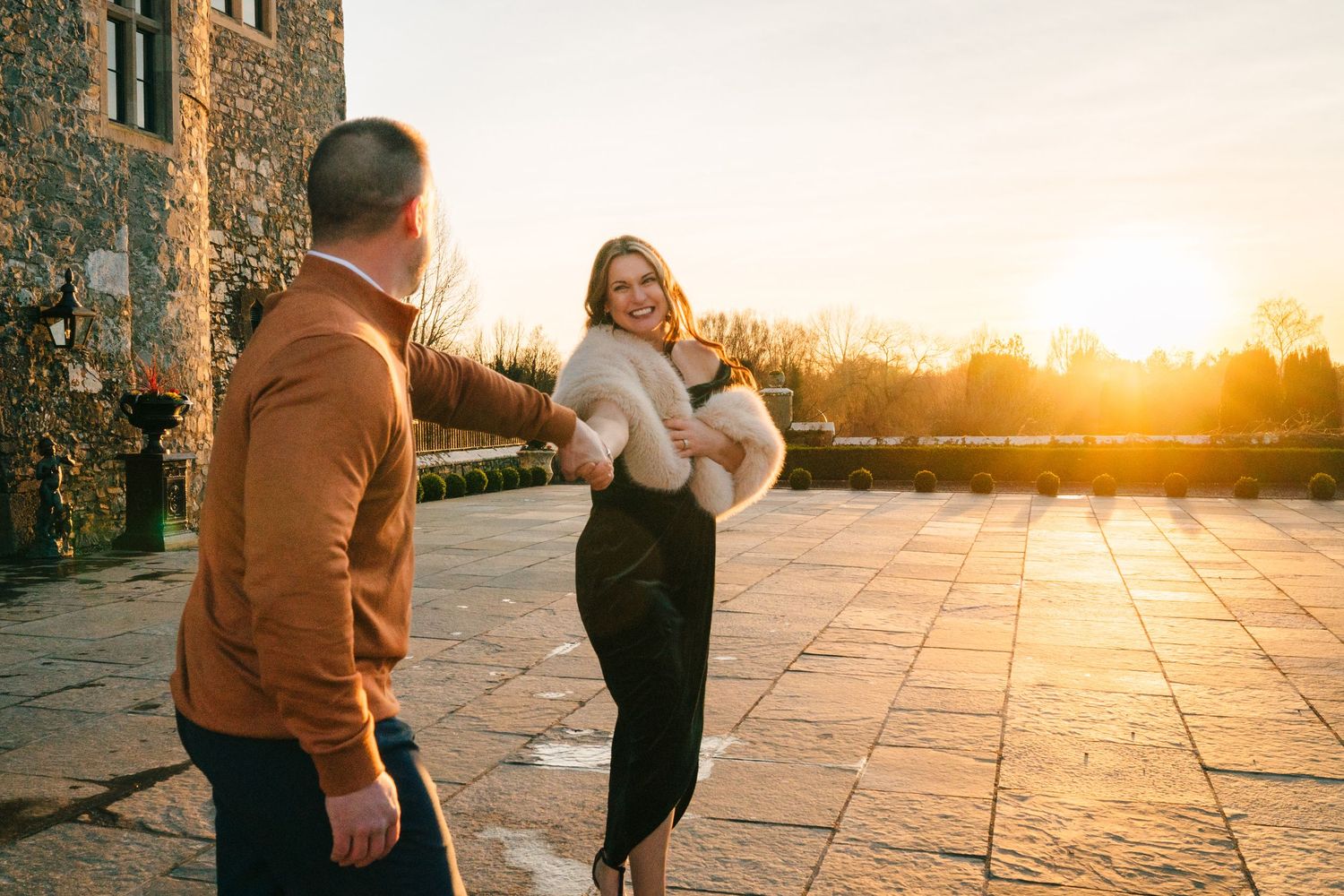 A romantic sunset moment at a castle courtyard with golden light streaming behind. PHOTOGRAPHER Dublin ireland