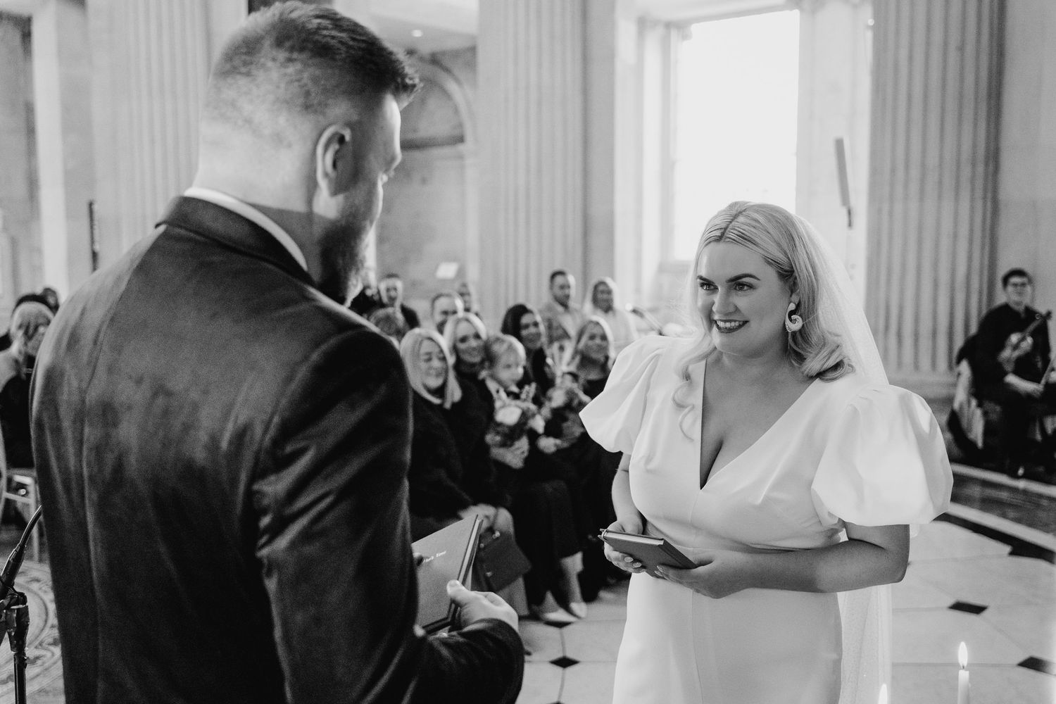 Elegant wedding ceremony moments captured in a classical architectural setting.Wedding photographer dublin