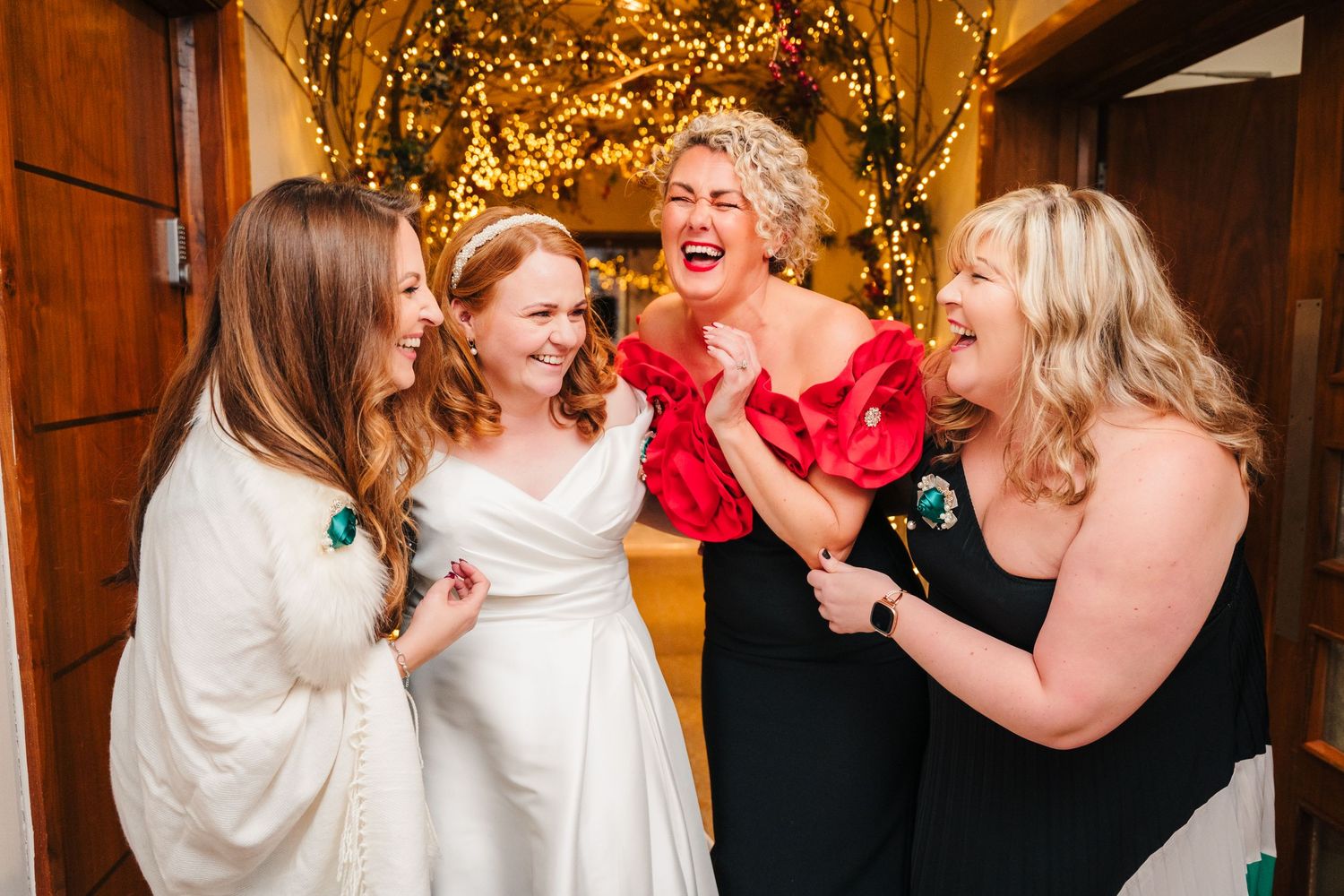 Wedding celebration with guests laughing and dancing under warm string lights in rustic venue.  Wedding PHOTOGRAPHER Trim Castle