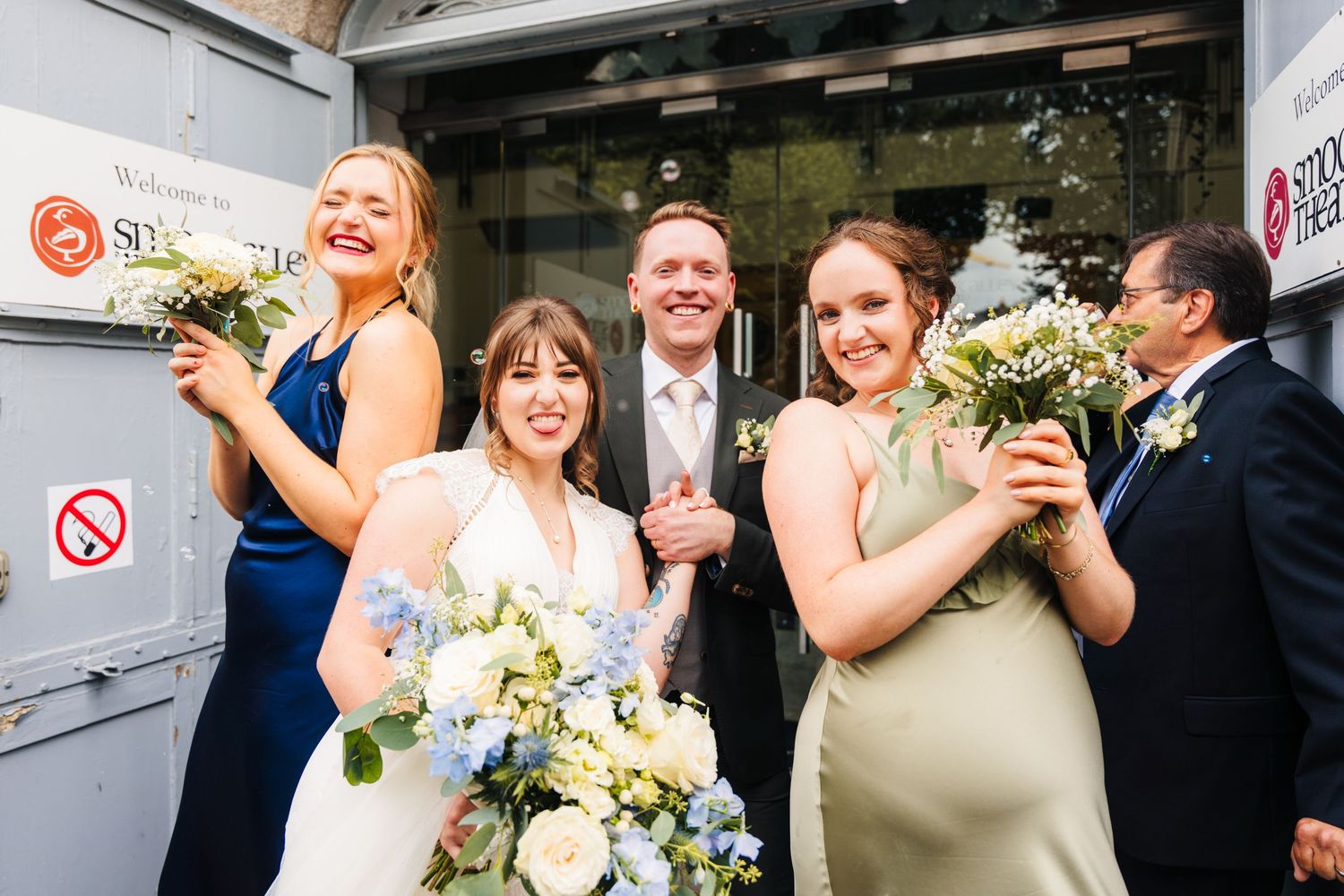 Wedding party celebrating with flowers and champagne outdoors. PHOTOGRAPHER Dublin Ireland Wedding