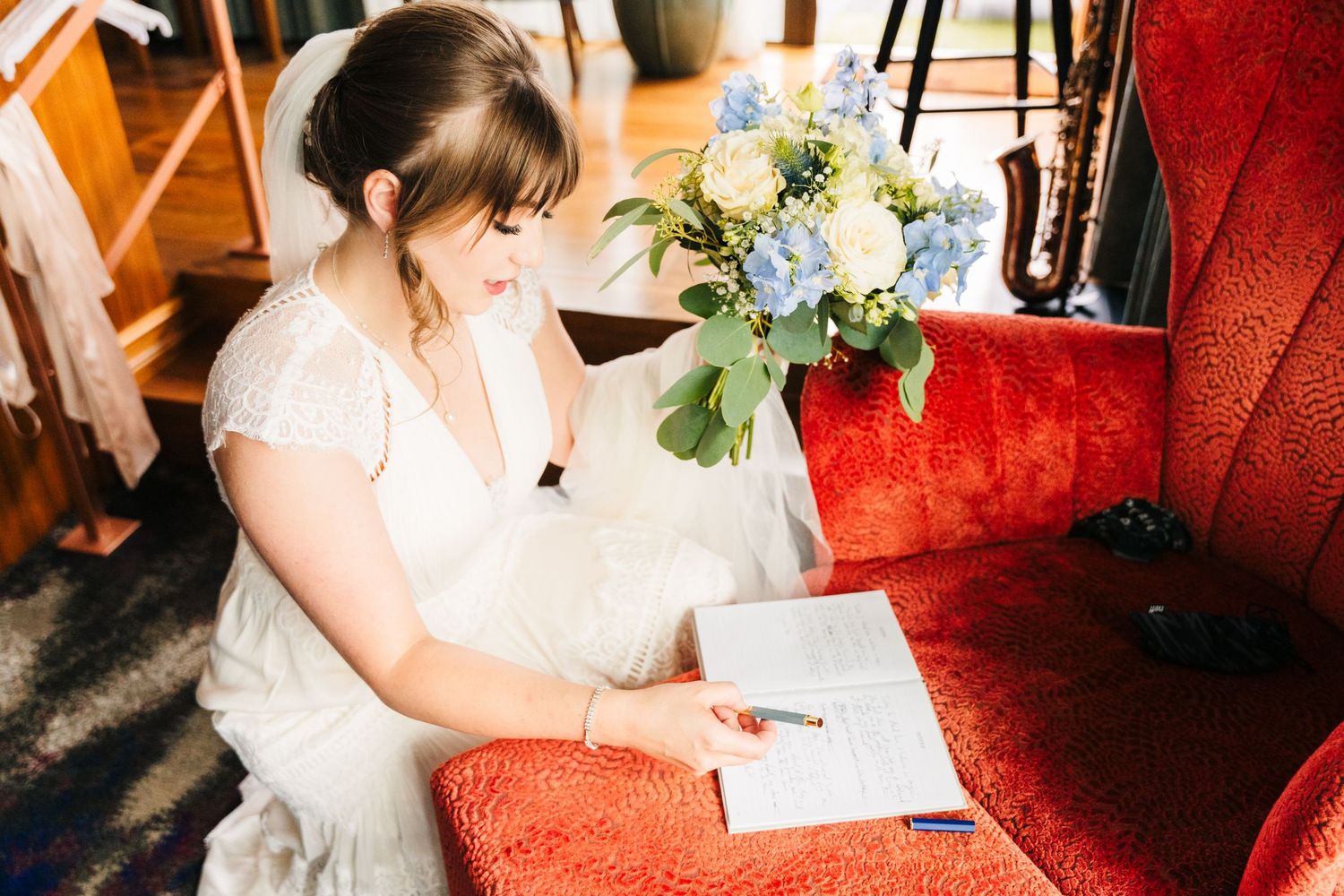 Elegant wedding venue interior with red velvet seating and floral arrangements. PHOTOGRAPHER Dublin Ireland Wedding