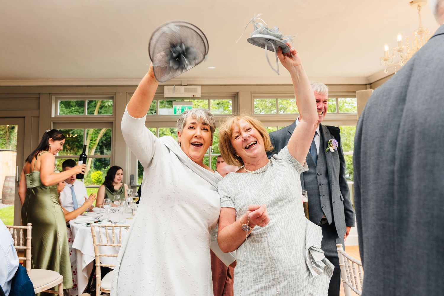 Millhouse slane wedding photographer dublin Two wedding guests celebrate enthusiastically during reception festivities.