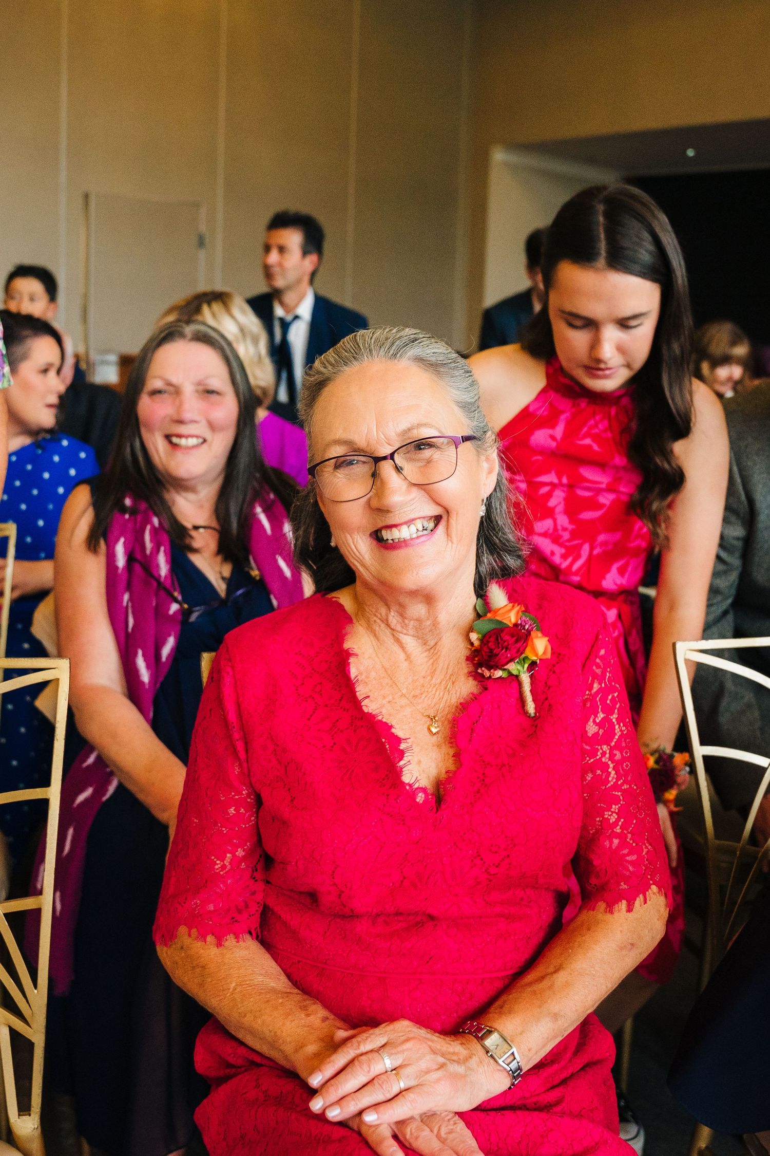 Wedding guests in colorful attire seated at round tables during reception celebration. Wedding Photography Trim Castle Ireland