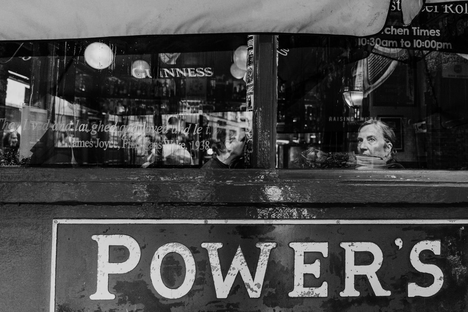 A long storefront illuminated at night with vintage neon signage and window displays on the exterior. Proposal Dublin Photographer