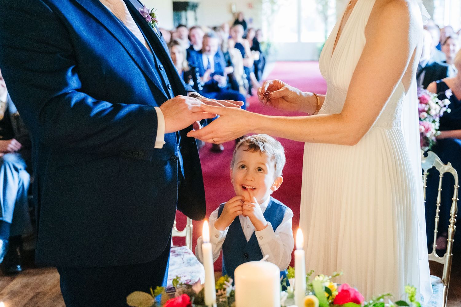 Elegant wedding reception setup with guests mingling around decorated tables in a grand ballroom. Wedding Photographer Dublin Ireland