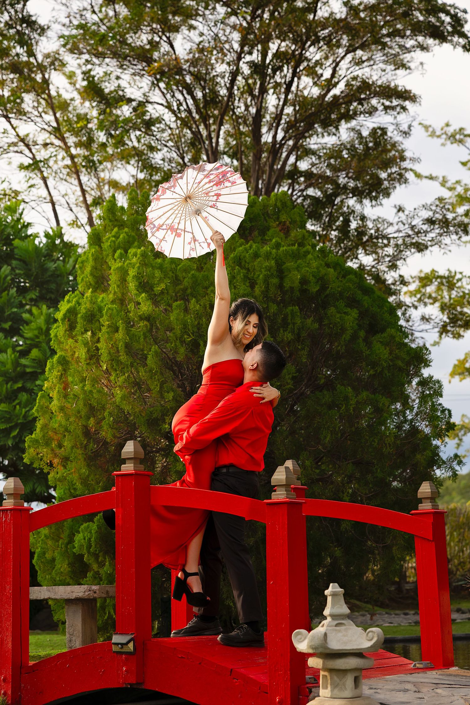 A series of photos showing a traditional Japanese garden scene with a red arched bridge and decorative paper parasol.