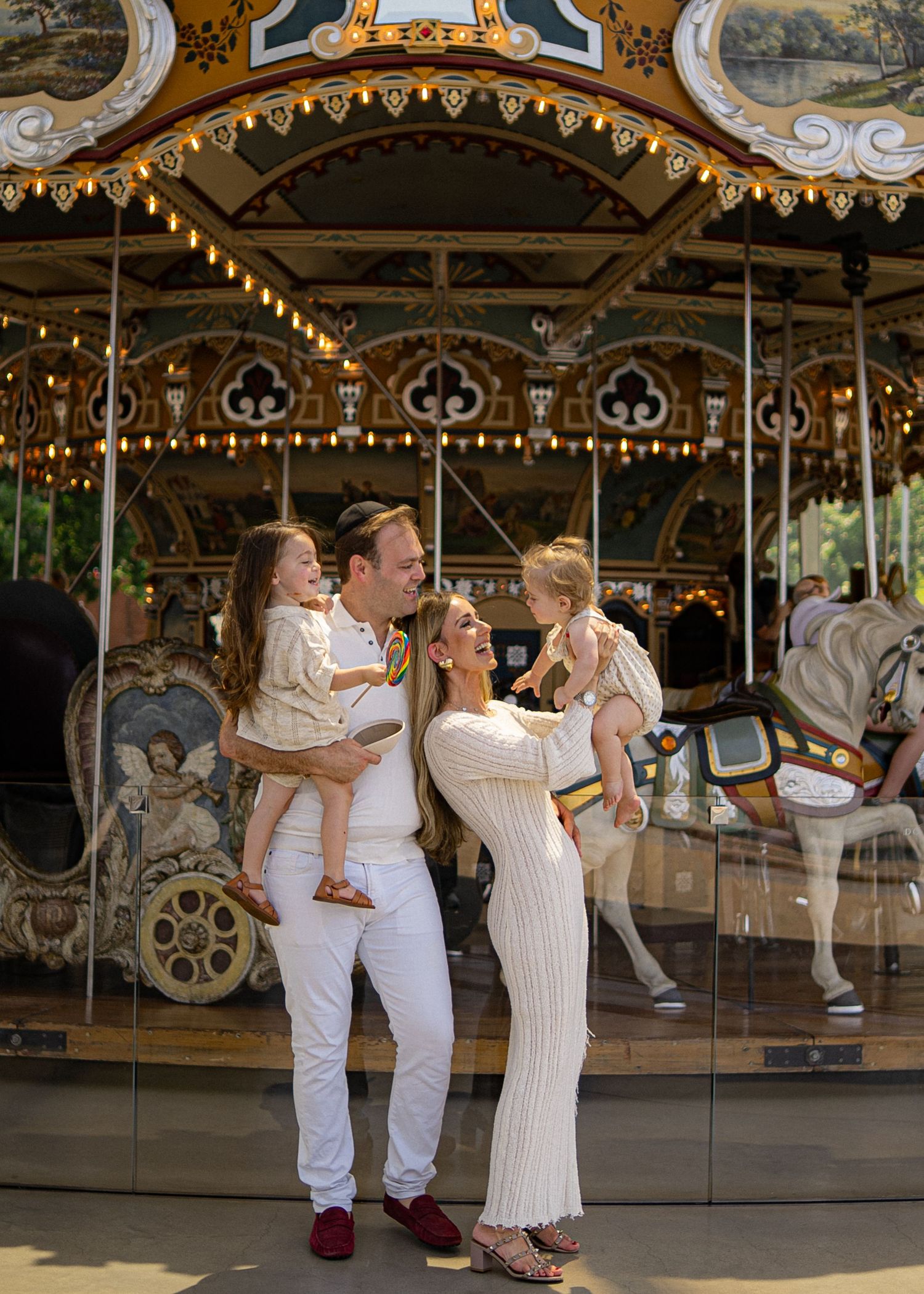 A family in front of a vintage carousel in brooklyn, jane carousel