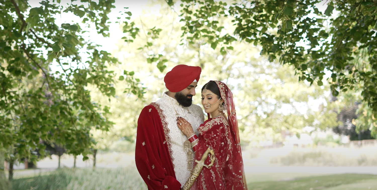 Traditional wedding couple in outdoor garden setting with soft natural lighting.