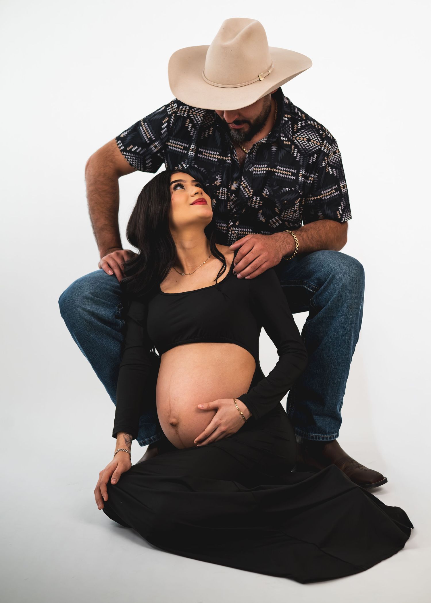 A maternity photo sequence showing a pregnant woman in black dress with someone in jeans and cowboy hat.