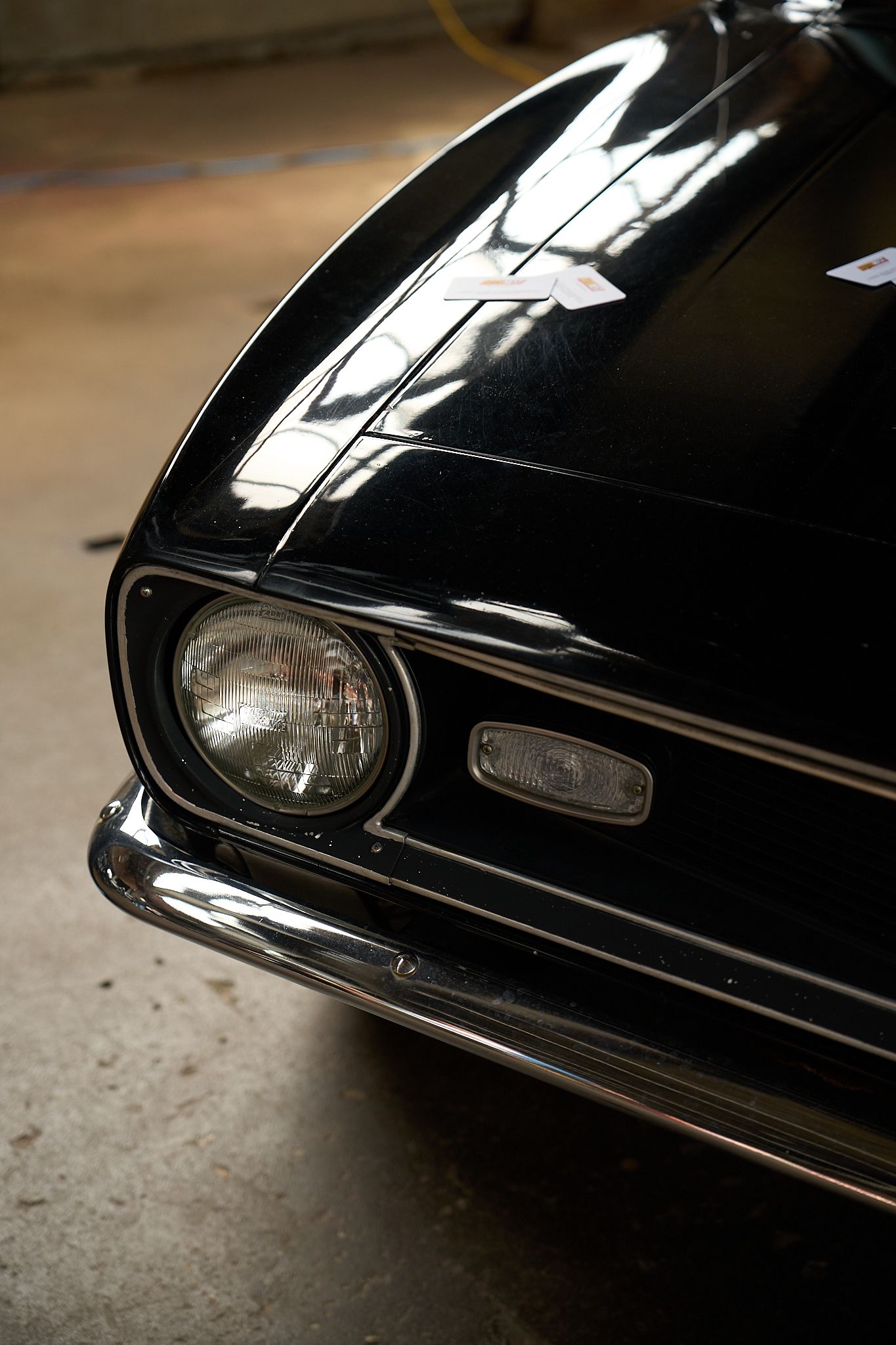 car photography, detail shot of a black muscle car