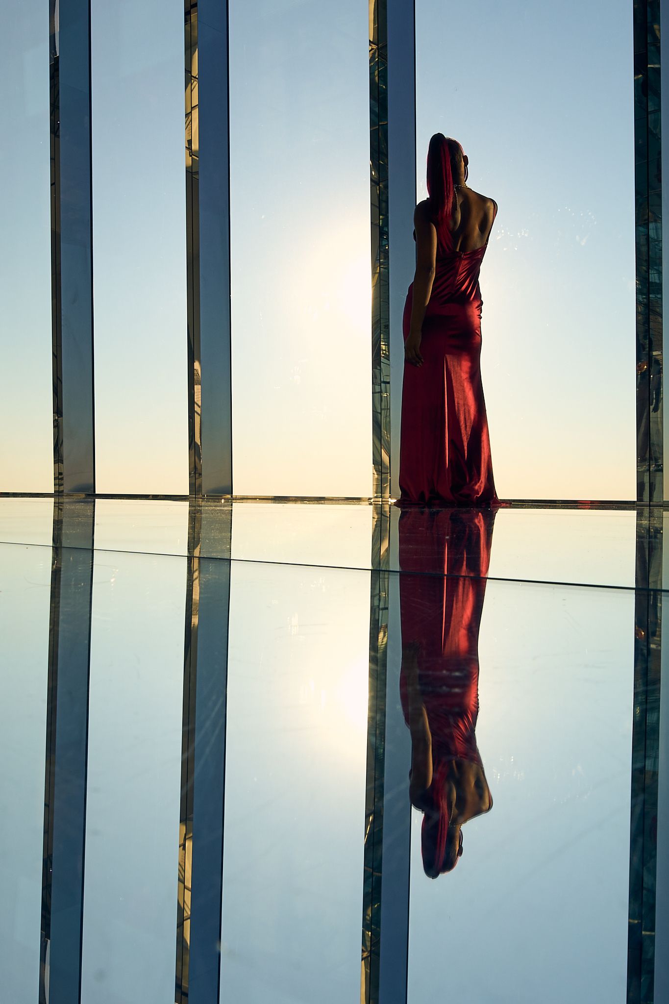 travel and editorial photography, NY, women in red dress at the top of the one Vanderbilt building