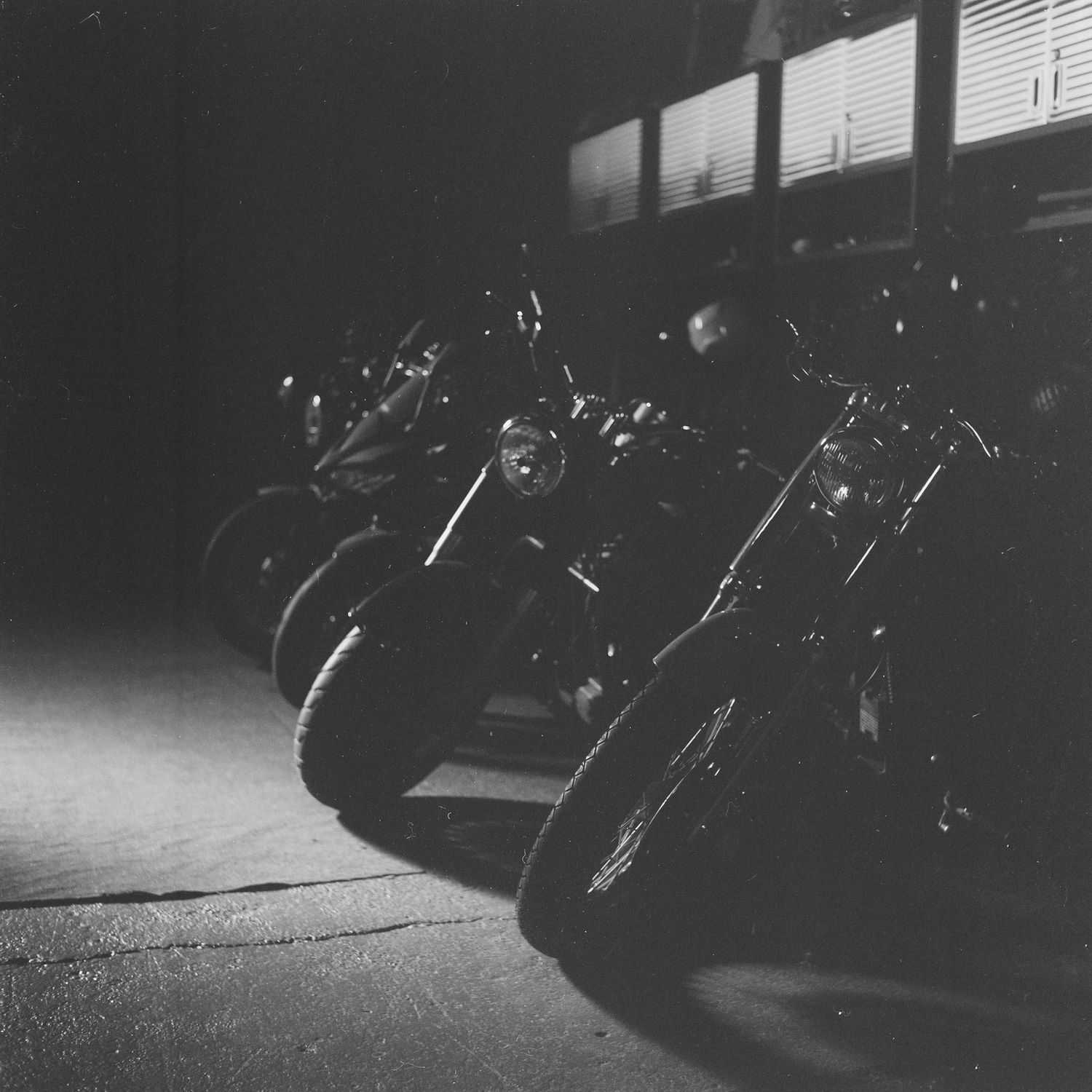 motorcycle and helmet, triumph scrambler 1200, black and white film photography