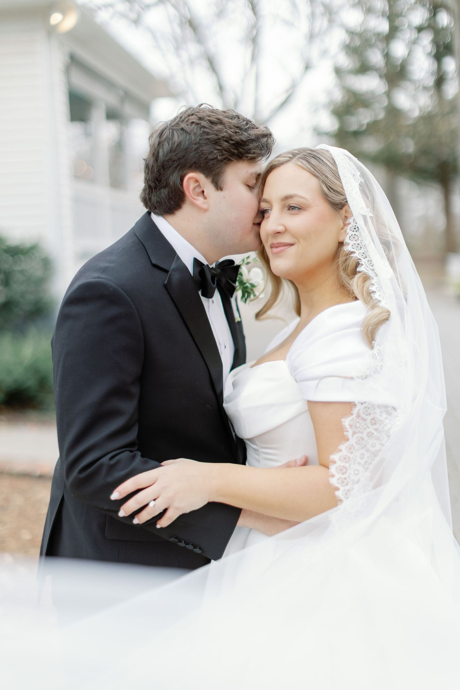Romantic wedding couple shares intimate kisses in series of dreamy outdoor portrait photographs.