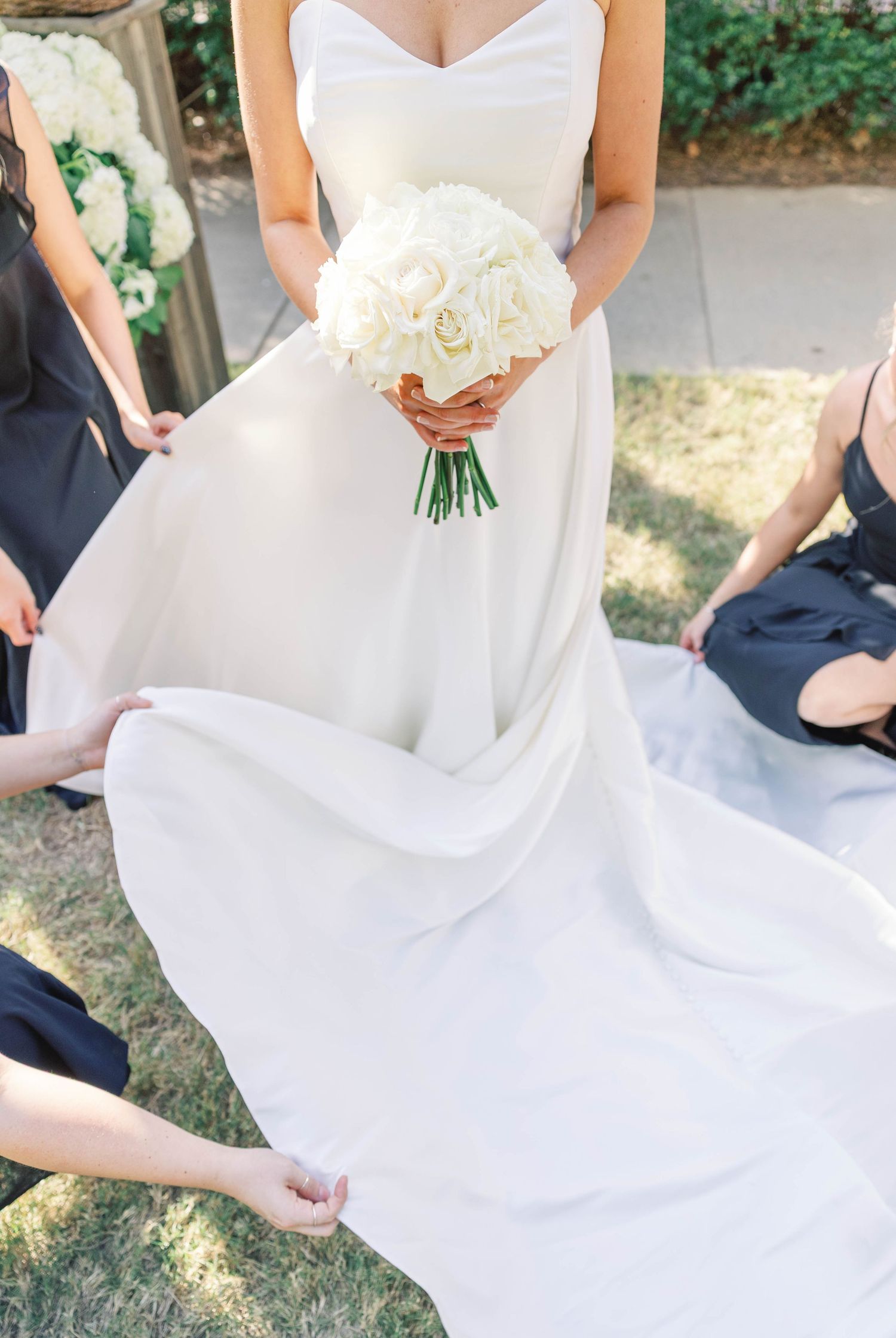 Detail shots of a classic white wedding dress with sweetheart neckline and flowing train.