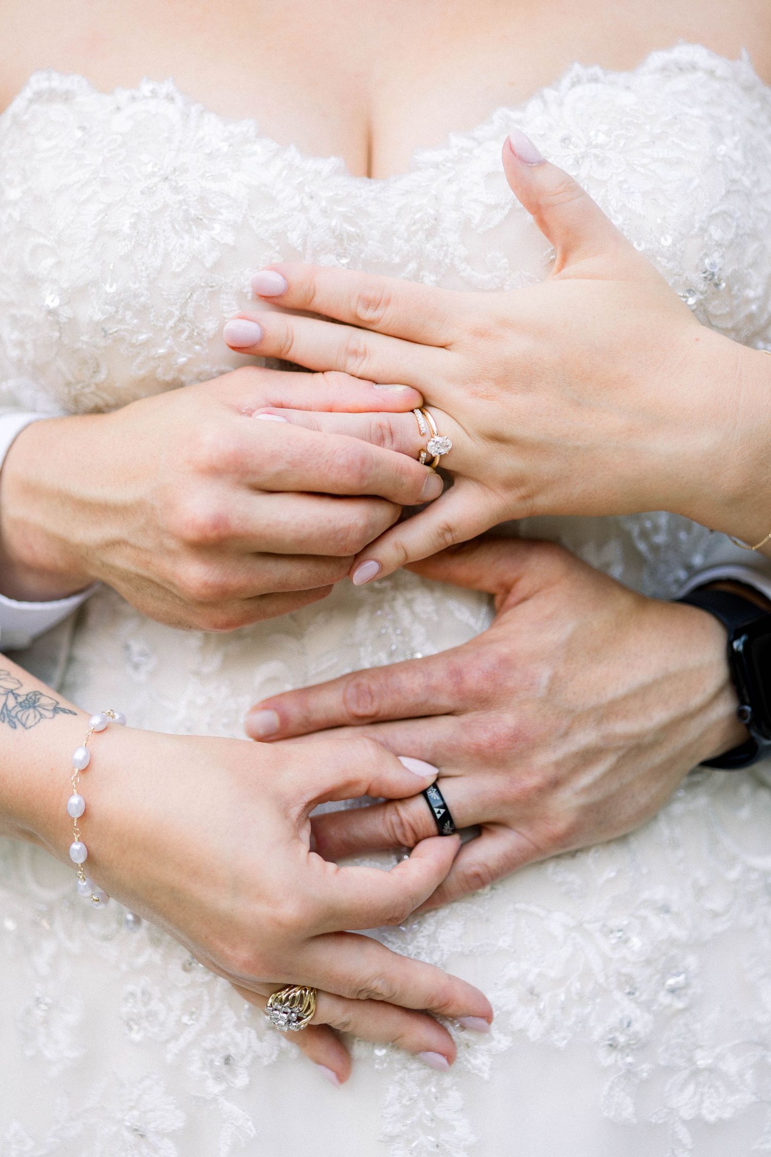 Close-up shots showing hands exchanging rings during a wedding ceremony with delicate lace details.