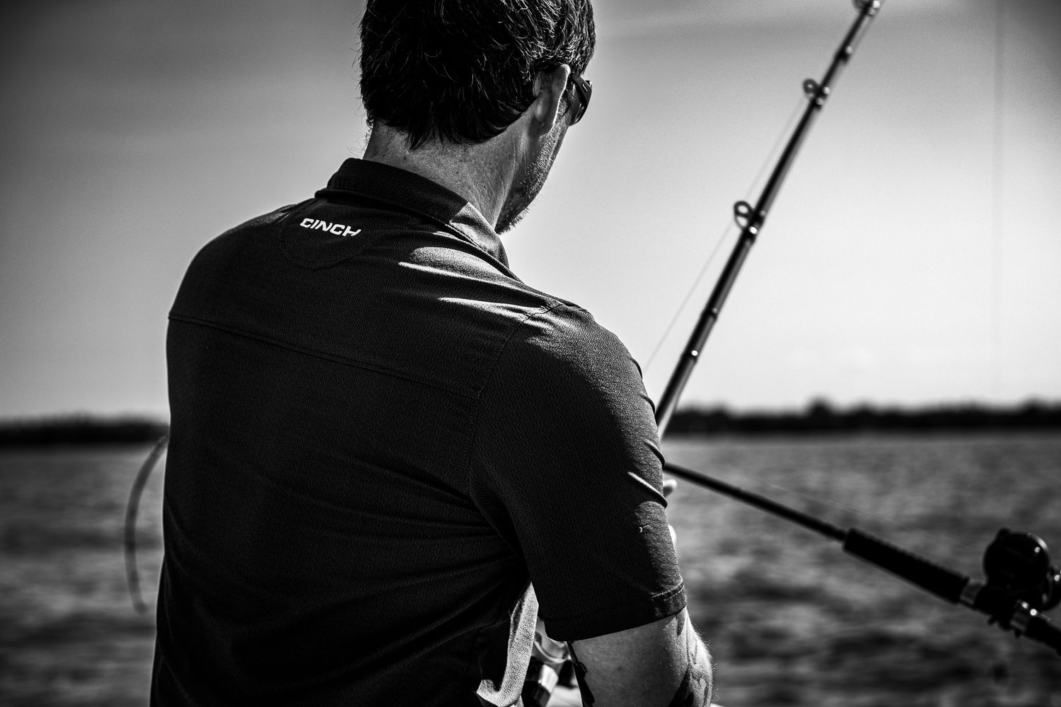 A black and white photo montage showing a person kiteboarding on water with dramatic sky and waves.
