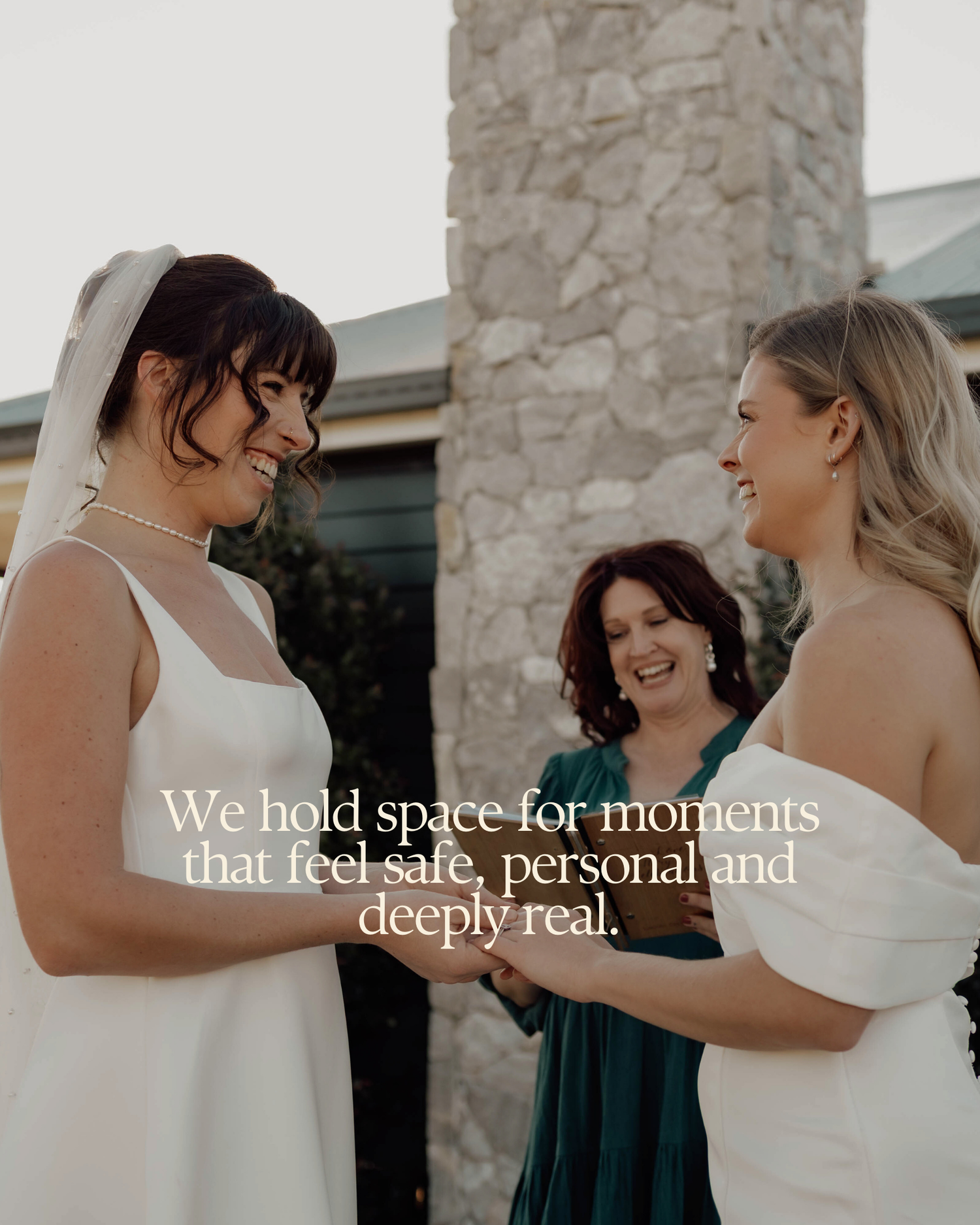 Two brides exchange vows outdoors, smiling joyfully, as a celebrant officiates their intimate wedding ceremony.