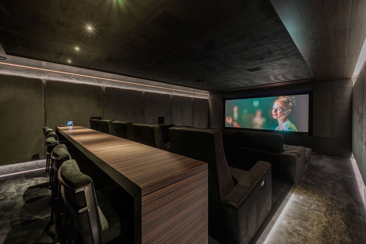 Dark contemporary lounge area with ambient lighting and luxurious furnishings.