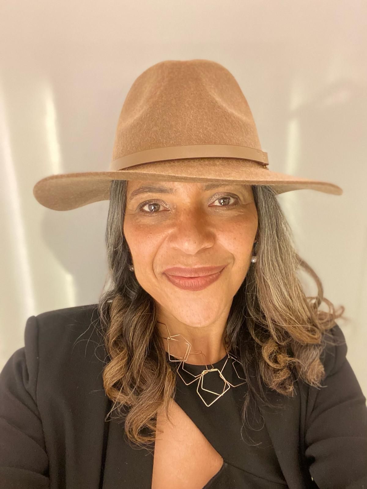 Joanne Scali, wearing a hat, looking straight into the camera, talks about her positive coaching experience