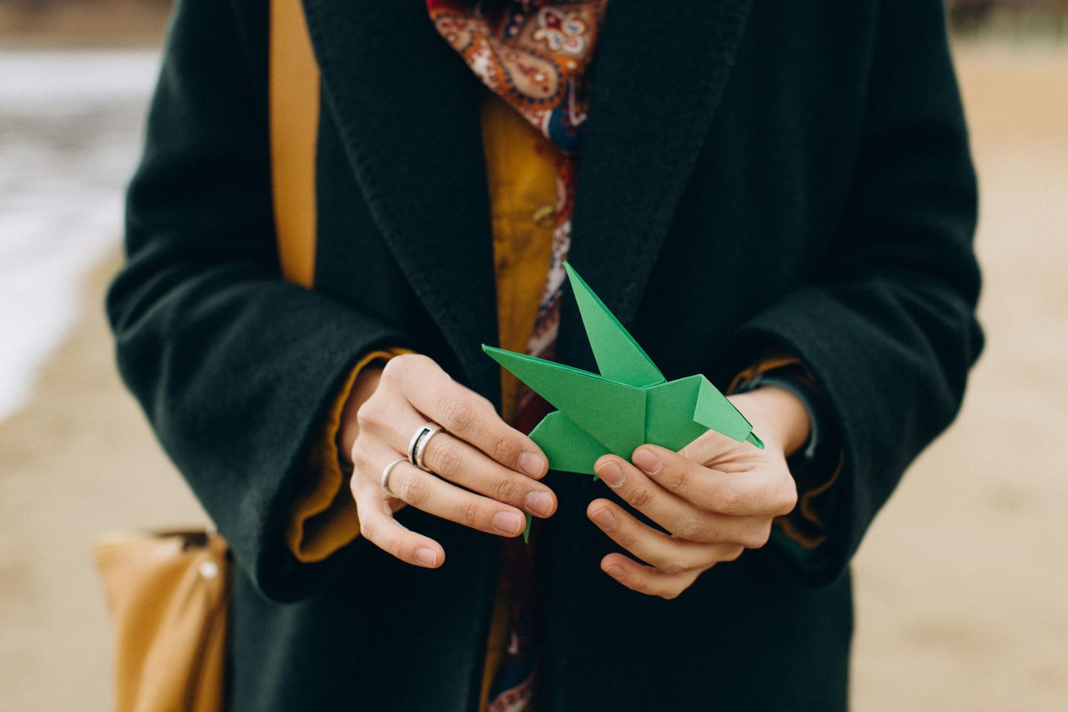 Camelia Graur, coach, facilitator, mentor, holding an origami in the shape of a bird
