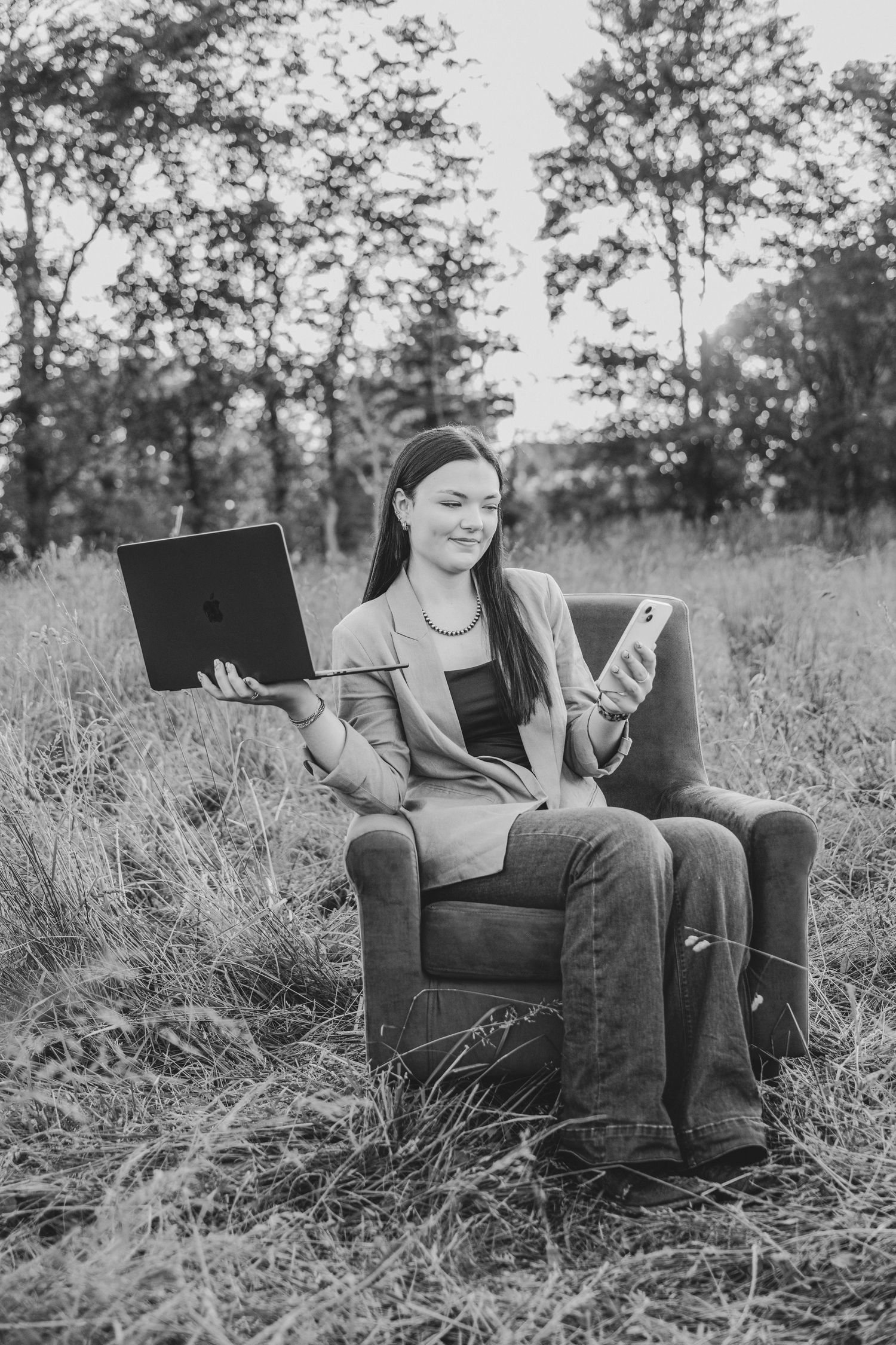 A sequence of black and white photos showing someone sitting casually in an armchair outdoors in tall grass.