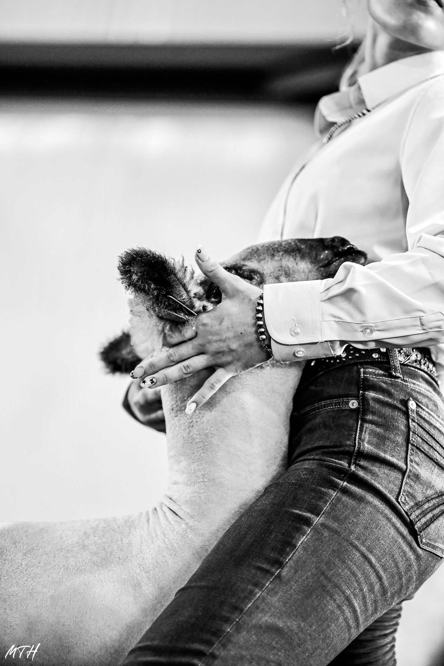 A series of black and white images showing a person in jeans being adjusted or fitted in different angles.