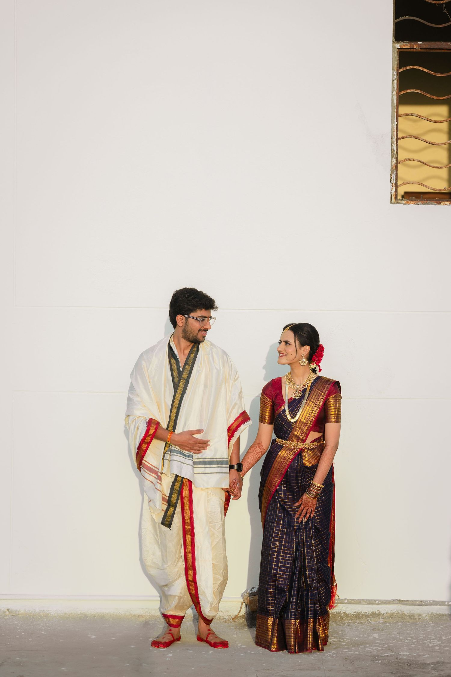 Traditional Indian dancers performing a cultural dance drama sequence in traditional white and colorful costumes.