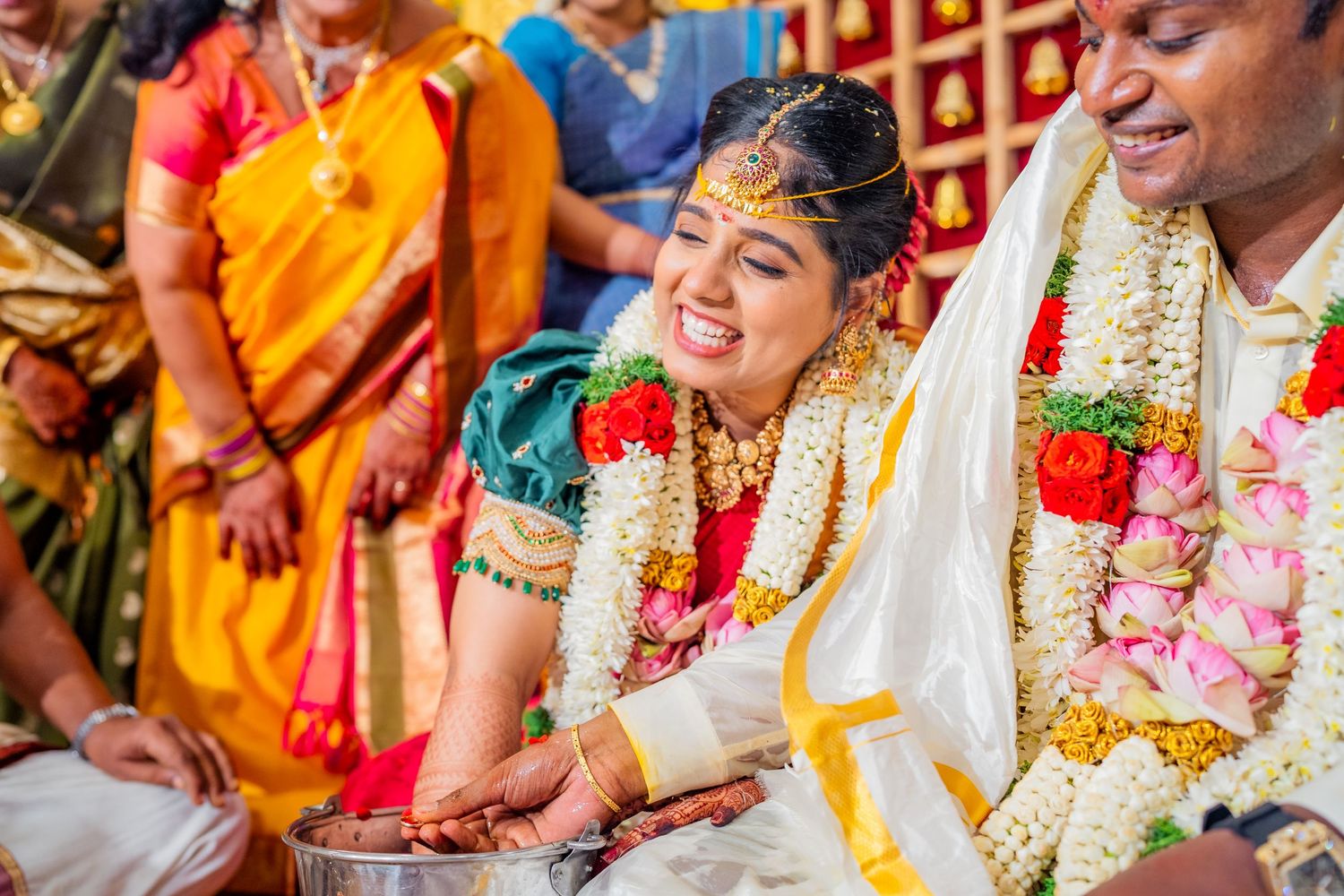 A traditional South Indian wedding ceremony with the couple wearing garlands and traditional attire.