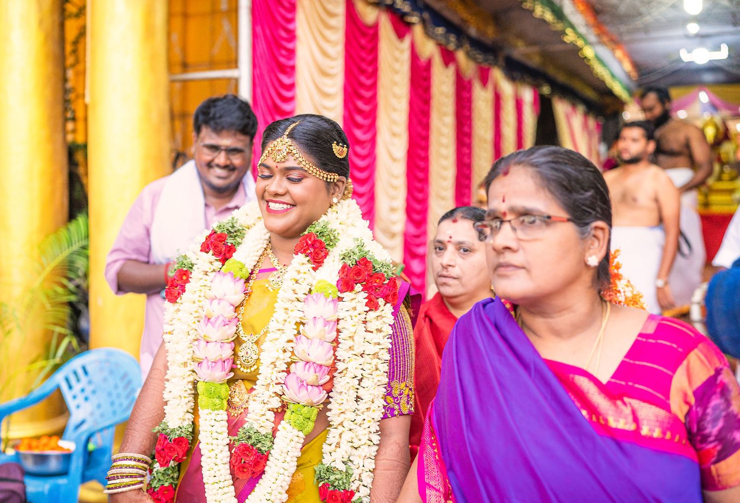Festive celebration with traditional flower garlands and vibrant decorations at an Indian cultural ceremony.