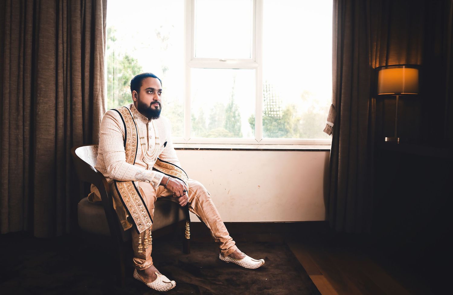 Traditional Indian formal wear captured in natural window light setting.